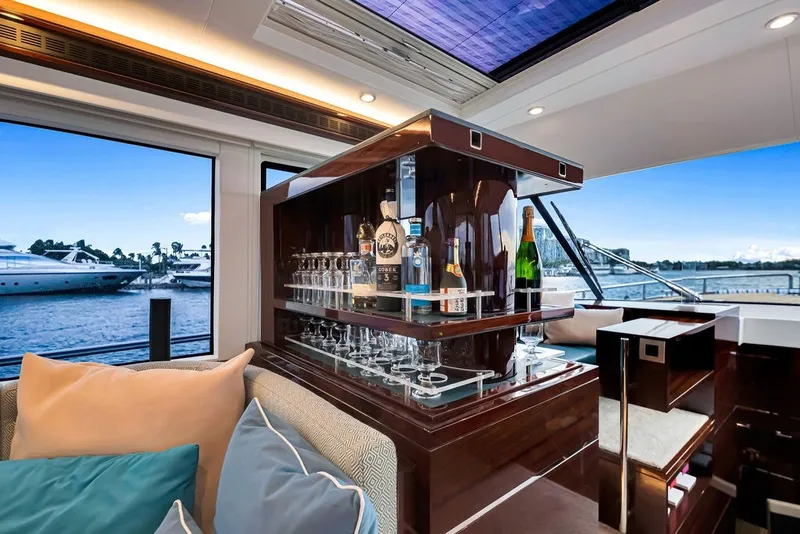 Slide: The Image of Luxurious interior of 2021 Steeler 60S yacht with elegant bar setup and scenic marina view. - 72