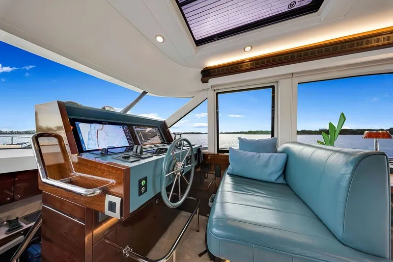 Slide: The Image of Helm of 2021 Steeler 60S yacht with modern controls and blue seating. - 77