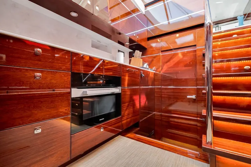 Slide: The Image of Luxurious wooden kitchen interior on a 2021 Steeler 60S yacht, featuring modern appliances and elegant design. - 89