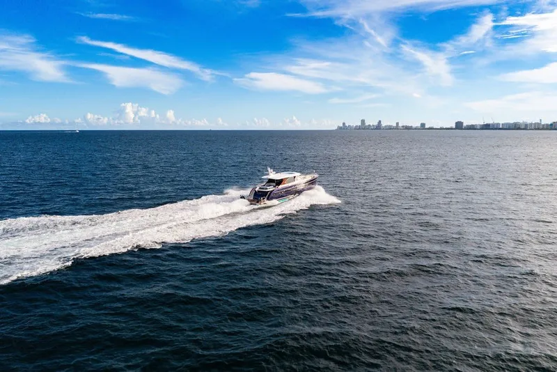 Slide: The Image of Luxury Steeler 60S yacht cruising on open sea, 2021 model, under clear blue skies. - 33