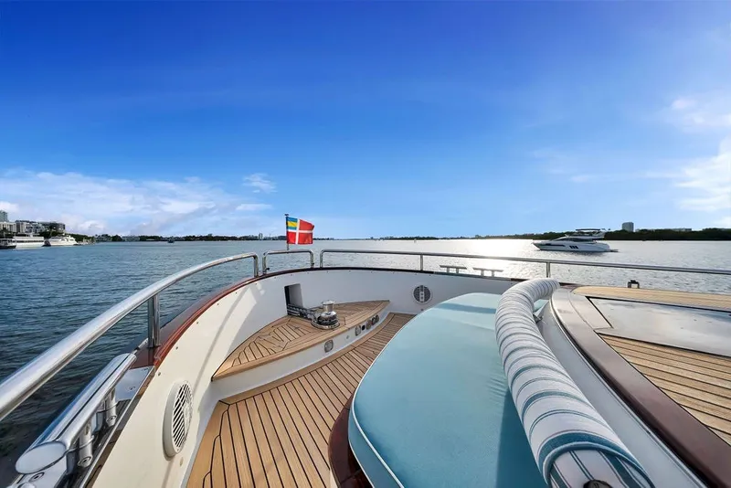 Slide: The Image of Luxurious 2021 Steeler 60S yacht deck with scenic ocean view and vibrant flag. - 64