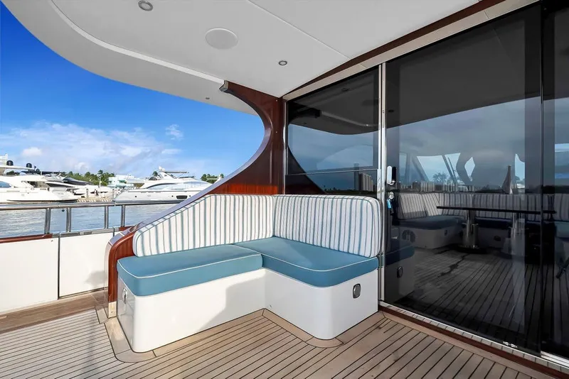 Slide: The Image of Luxury yacht Steeler 60S 2021 with elegant deck seating and marina view. - 60