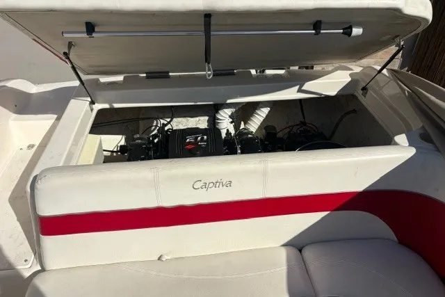 Slide: The Image of 2002 Rinker 212 Captiva Bowrider engine compartment with open hatch, showcasing interior details. - 13