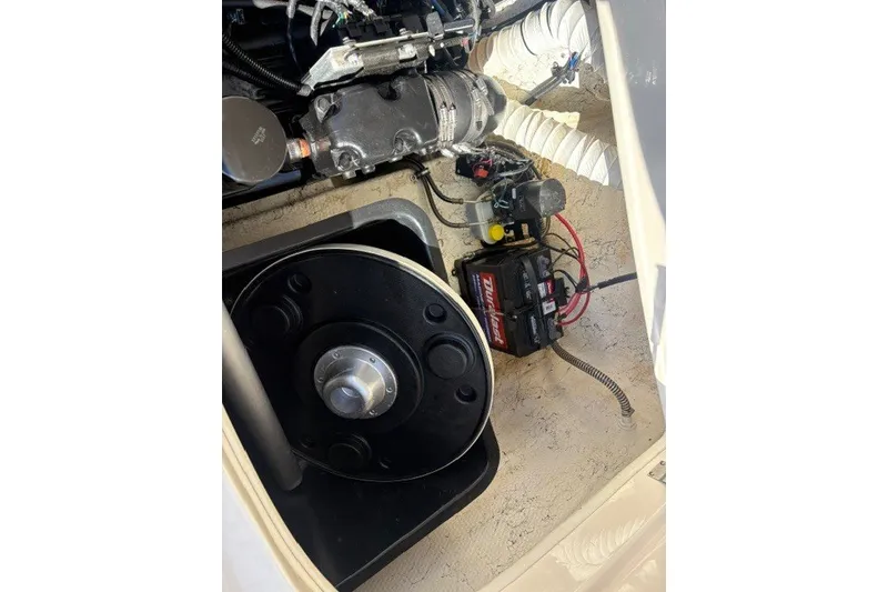 Slide: The Image of Engine compartment of a 2002 Rinker 212 Captiva Bowrider with visible battery and components. - 15