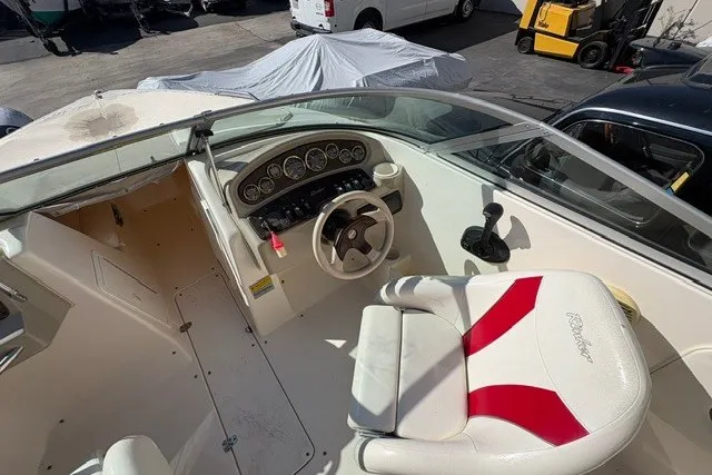 Slide: The Image of 2002 Rinker 212 Captiva Bowrider cockpit with steering wheel and instrument panel. - 7