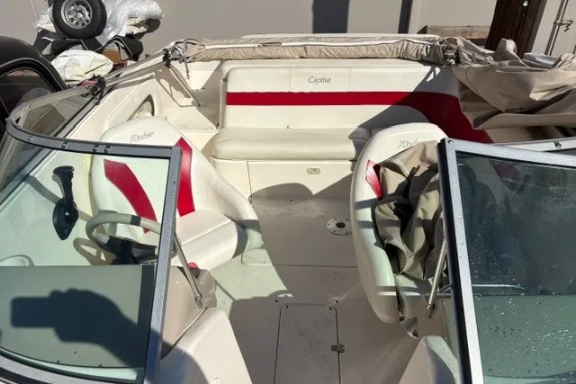 Slide: The Image of 2002 Rinker 212 Captiva Bowrider with red and white interior, featuring dual seating and windshield. - 11
