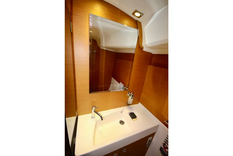 Slide: The Image of Elegant bathroom interior of 2012 Jeanneau Sun Odyssey 509 yacht with modern sink and mirror. - 7