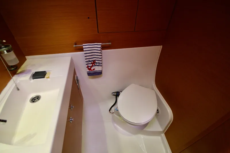 Slide: The Image of Bathroom interior of 2012 Jeanneau Sun Odyssey 509 yacht, featuring sink and toilet. - 8