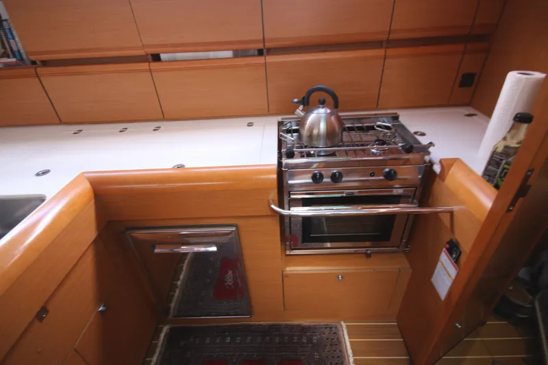 Slide: The Image of Galley kitchen in 2012 Jeanneau Sun Odyssey 509 yacht with stove and kettle. - 11