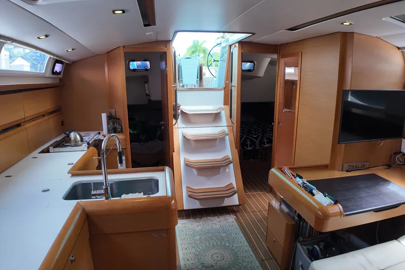Slide: The Image of Interior of 2012 Jeanneau Sun Odyssey 509 yacht, featuring modern kitchen and cozy living area. - 9