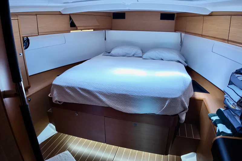 Slide: The Image of Interior cabin of 2012 Jeanneau Sun Odyssey 509 yacht with cozy bed and wooden finish. - 4