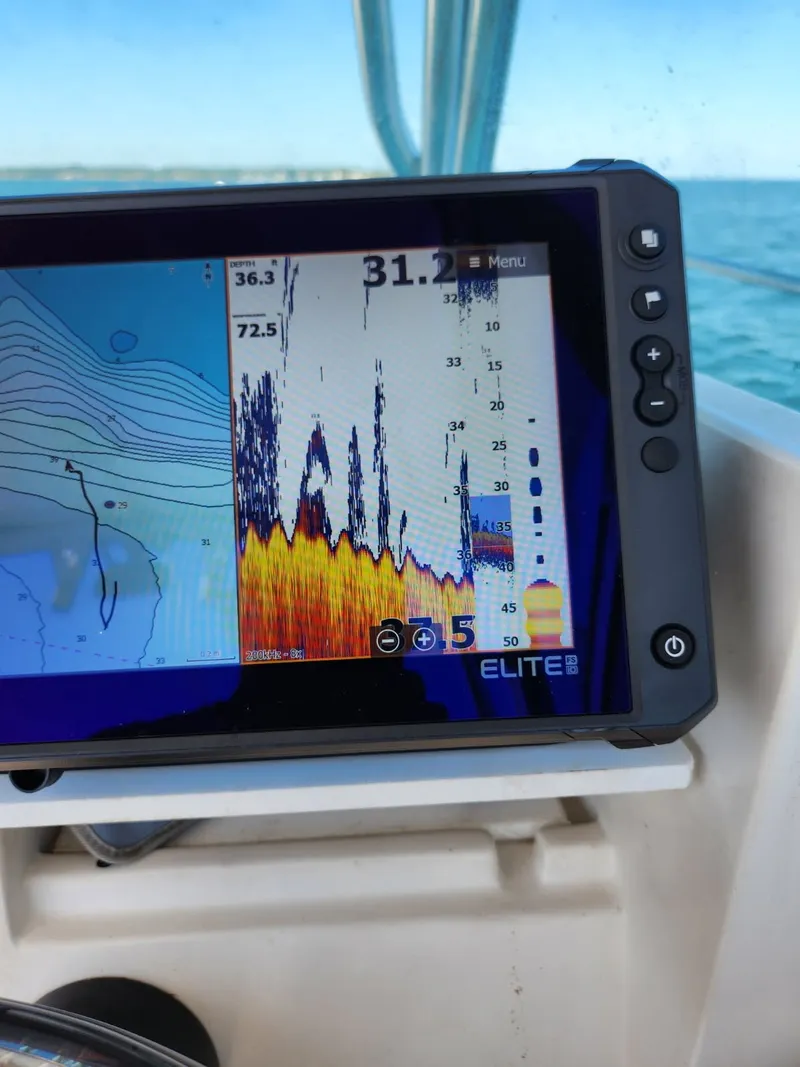 Slide: The Image of A fish finder display on a boat shows depth and temperature data. - 9