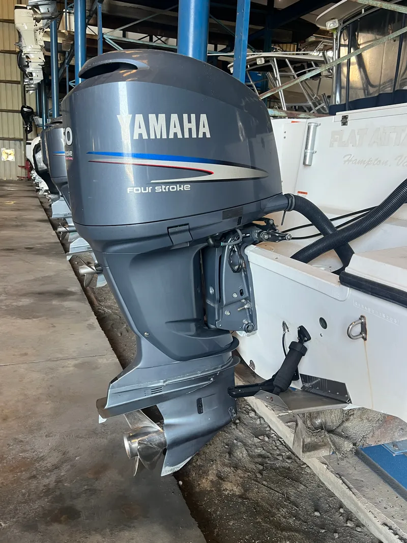 Slide: The Image of A Yamaha four-stroke outboard motor on a boat in storage. - 7