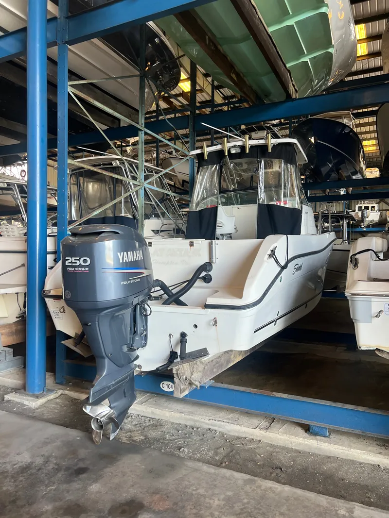 Slide: The Image of A 2003 Seaswirl Striper 2601 Walkaround O/B with a Yamaha outboard motor in storage. - 5