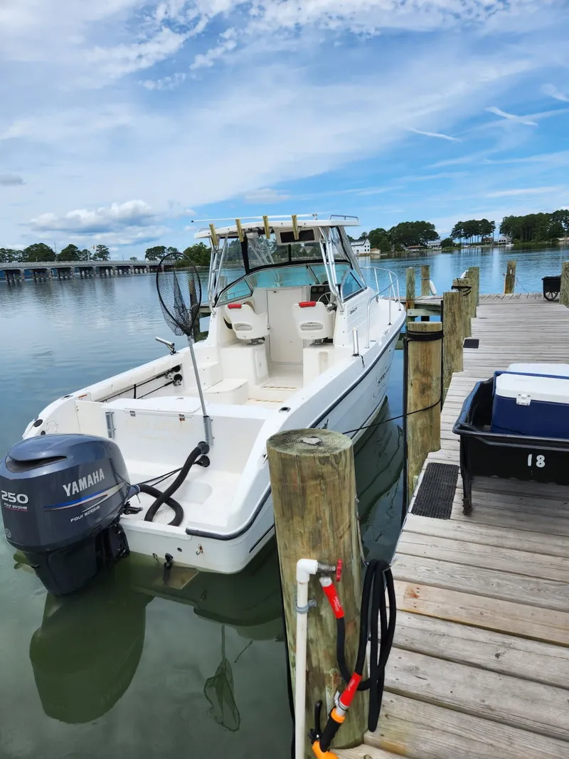 Slide: The Image of 2003 Seaswirl Striper 2601 Walkaround O/B at dock with Yamaha outboard motor. - 1