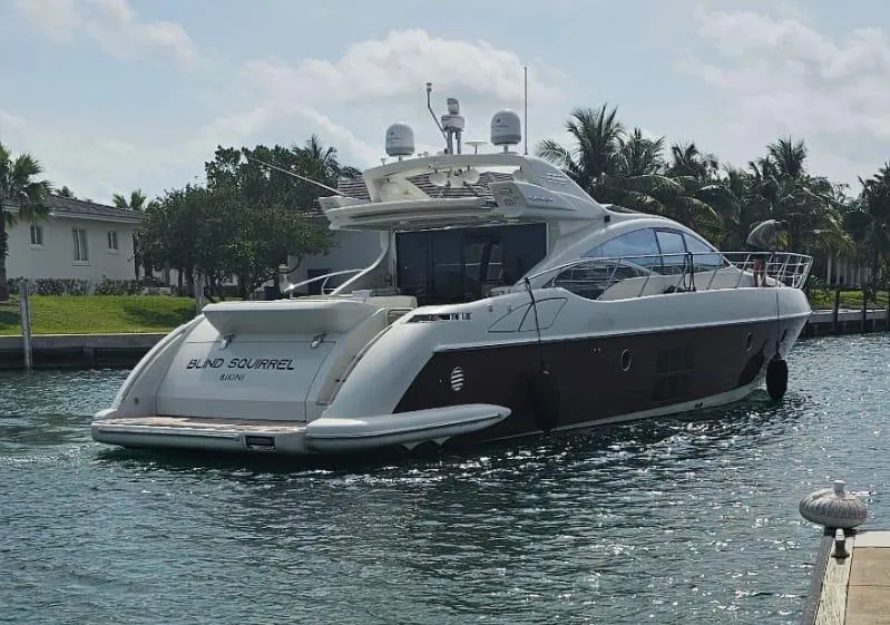 Slide: The Image of 2009 Azimut 68S yacht named Blind Squirrel docked in a tropical marina. - 1