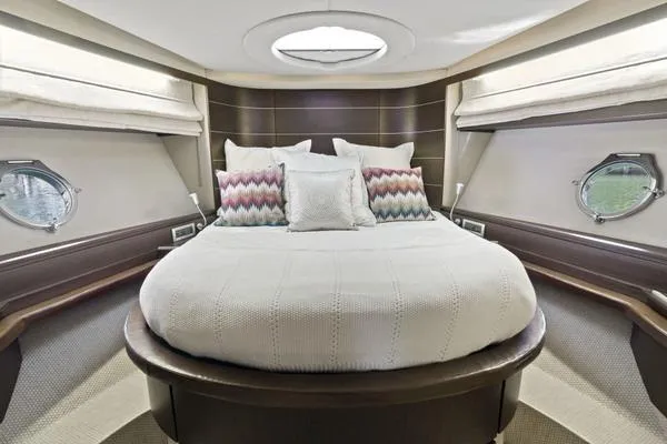Slide: The Image of Luxurious bedroom interior of 2009 Azimut 68S yacht with round bed and porthole windows. - 13