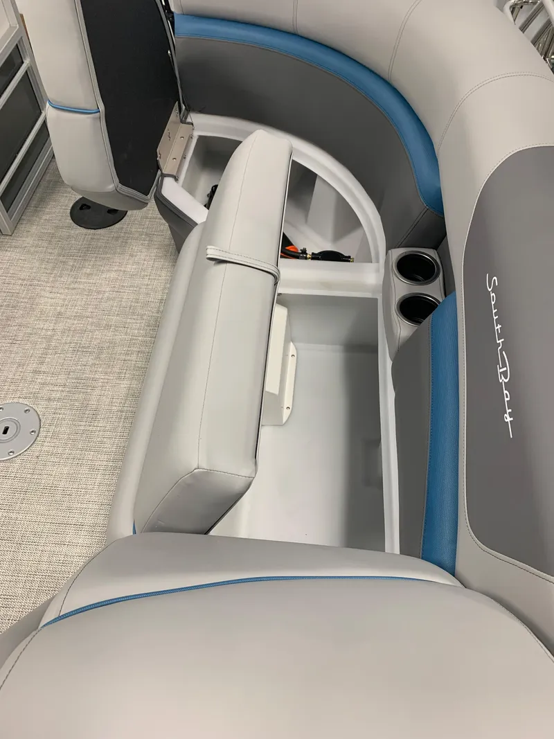 Slide: The Image of 2023 South Bay S224 RS boat interior with storage compartment and cup holders. - 28