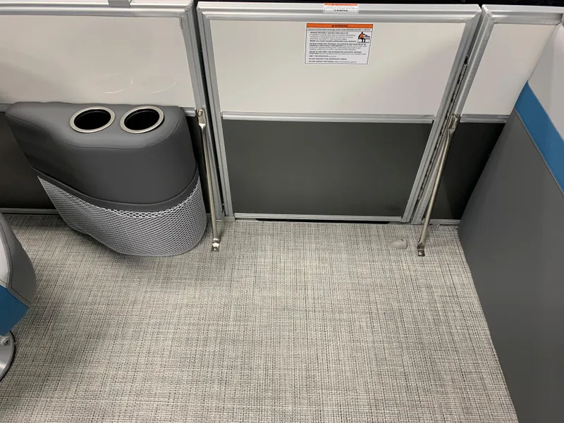 Slide: The Image of 2023 South Bay S224 RS boat interior with cup holders and safety gate. - 13