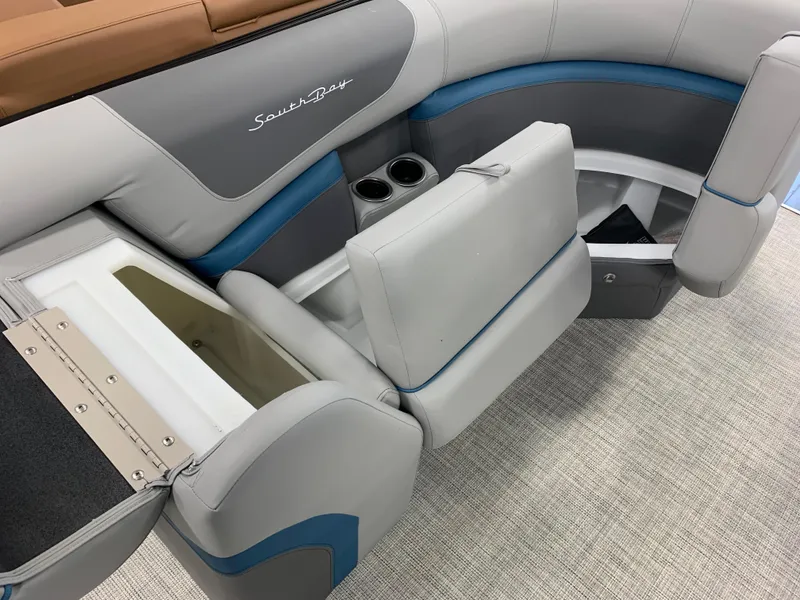 Slide: The Image of 2023 South Bay S224 RS boat interior with storage compartments and cup holders. - 16