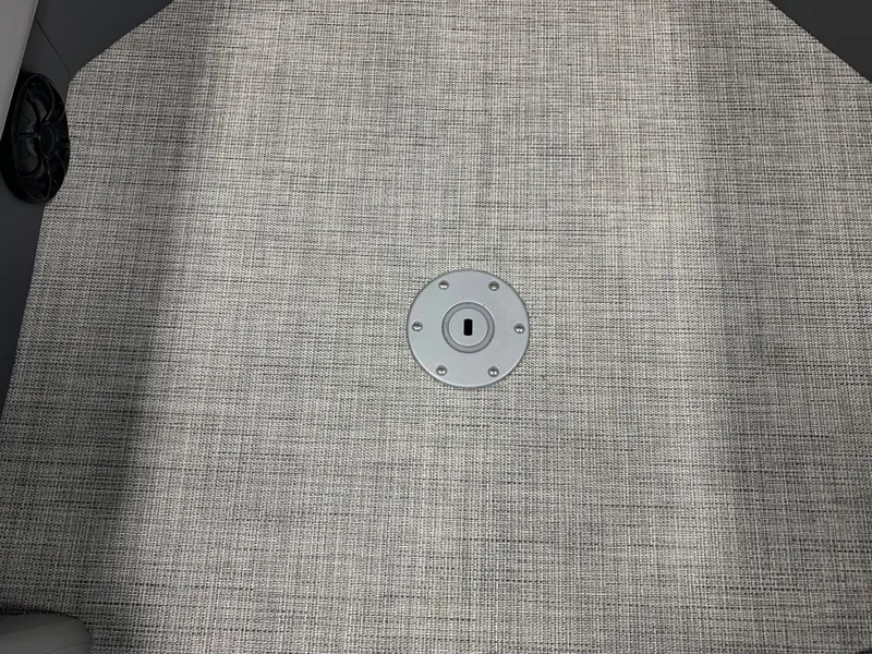 Slide: The Image of 2023 South Bay S224 RS boat floor with textured carpet and metal fixture. - 31