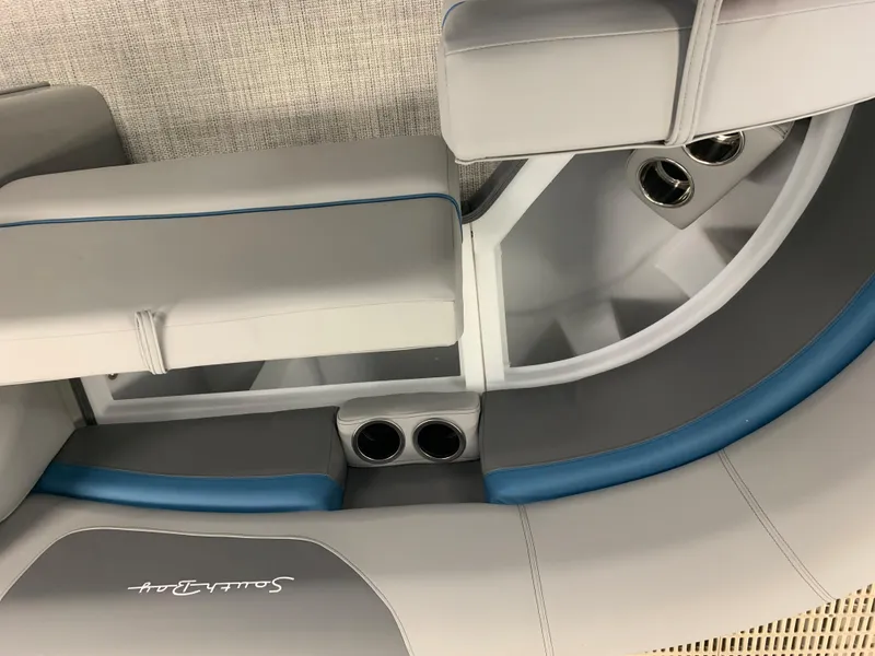 Slide: The Image of 2023 South Bay S224 RS boat interior with gray and blue seating and cup holders. - 19
