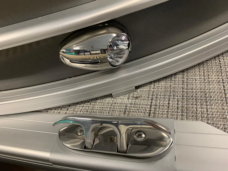 Slide: The Image of 2023 South Bay S224 RS boat hardware, including a cleat and light fixture. - 34