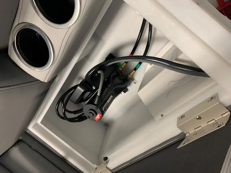 Slide: The Image of 2023 South Bay S224 RS boat interior compartment with wiring and cup holders. - 25