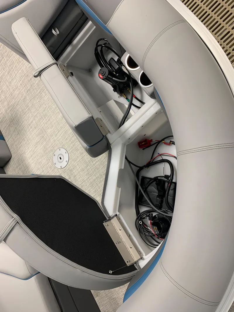 Slide: The Image of 2023 South Bay S224 RS boat interior storage compartment with wiring and cup holders. - 23