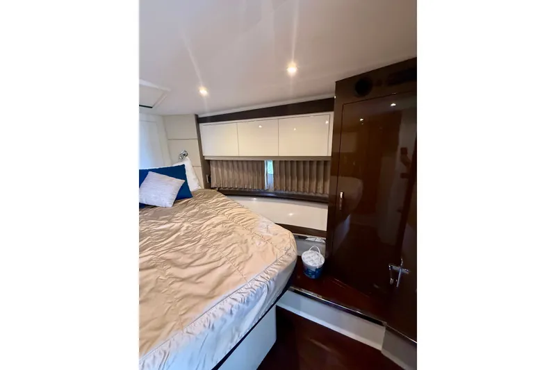 Slide: The Image of Interior of 2019 Carver C37 Coupe yacht bedroom with modern design and cozy bedding. - 40