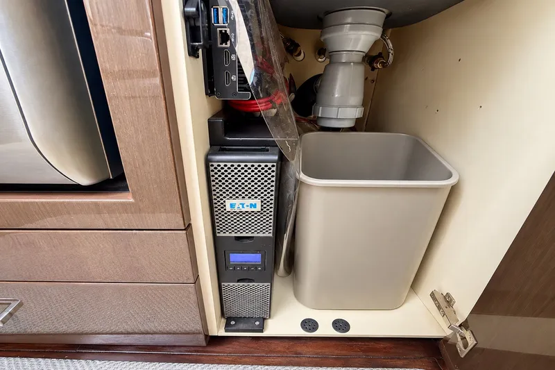 Slide: The Image of Under-sink storage in 2019 Carver C37 Coupe with Eaton power unit and waste bin. - 45