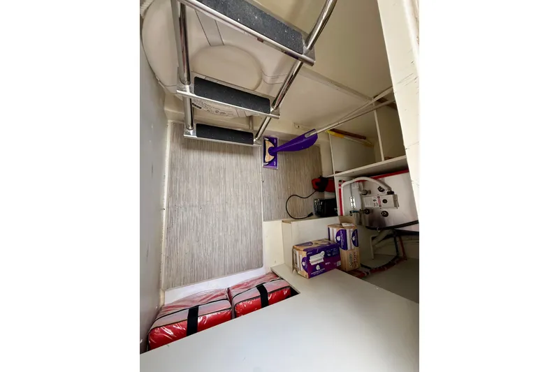 Slide: The Image of Interior of 2019 Carver C37 Coupe showing storage area with supplies and equipment. - 46