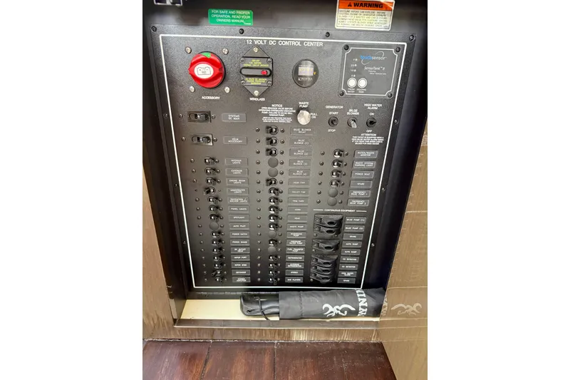 Slide: The Image of Control panel of a 2019 Carver C37 Coupe, featuring various switches and indicators. - 55