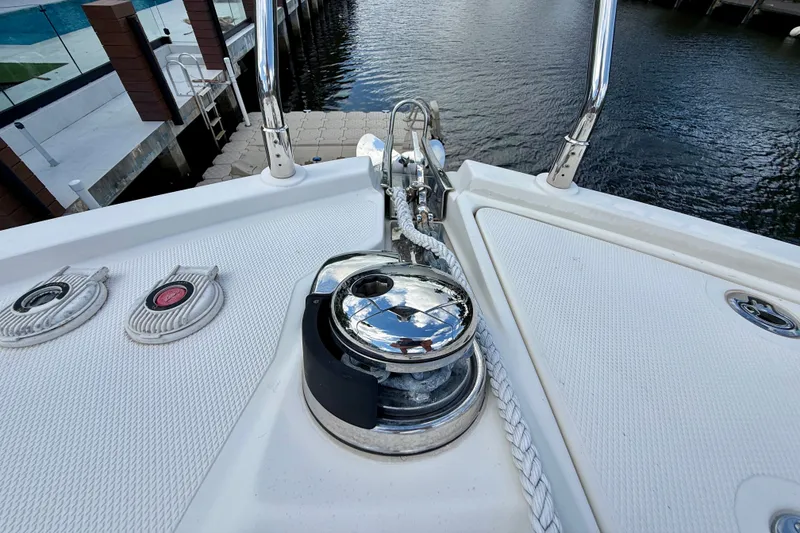 Slide: The Image of Bow of 2019 Carver C37 Coupe with anchor winch and rope, dockside view. - 29