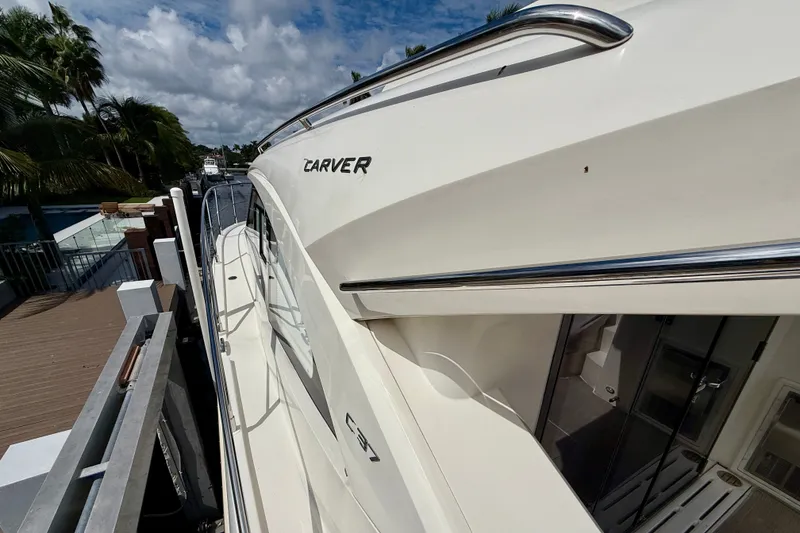 Slide: The Image of 2019 Carver C37 Coupe yacht docked, showcasing sleek design and luxurious features. - 21