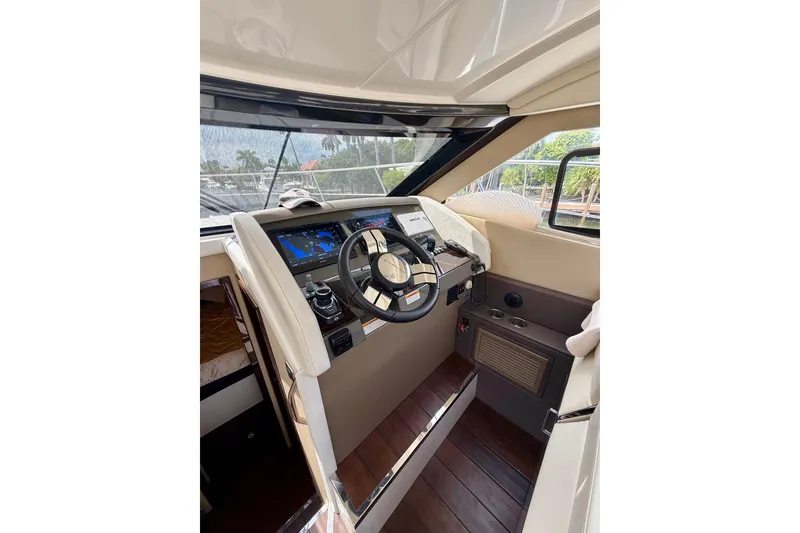 Slide: The Image of Interior cockpit of 2019 Carver C37 Coupe yacht with modern navigation controls. - 36