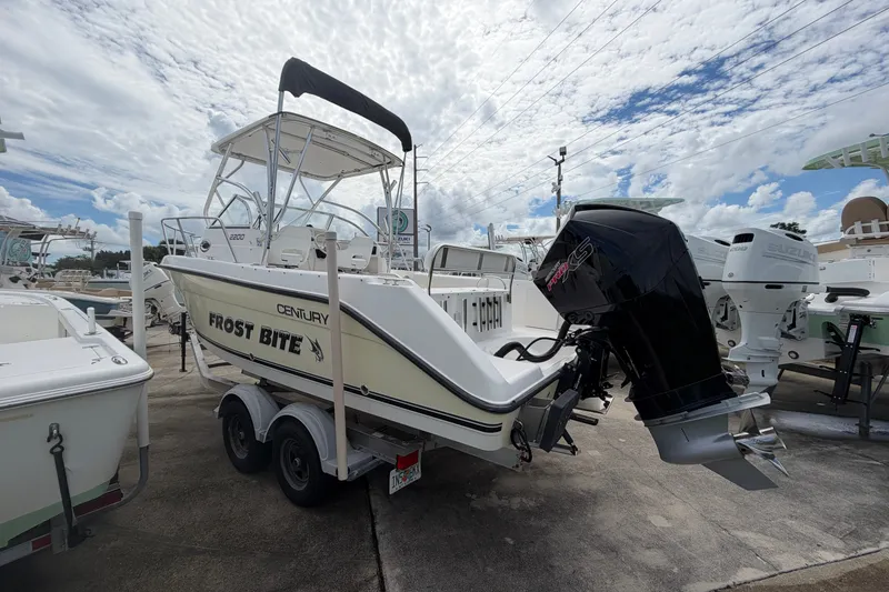 Slide: The Image of 2006 Century 2200 Walk-Around boat with outboard motor, parked on a trailer. - 3