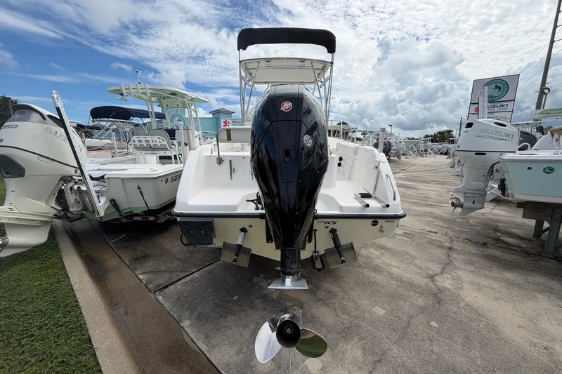 Slide: The Image of 2006 Century 2200 Walk-Around boat with outboard motor, displayed at a marina under cloudy skies. - 4