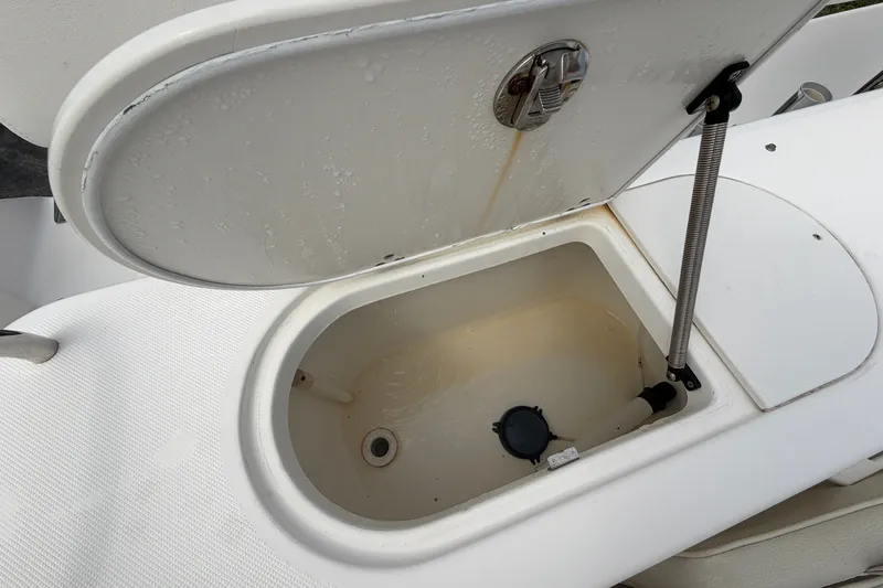 Slide: The Image of Open storage compartment on a 2006 Century 2200 Walk-Around boat. - 16