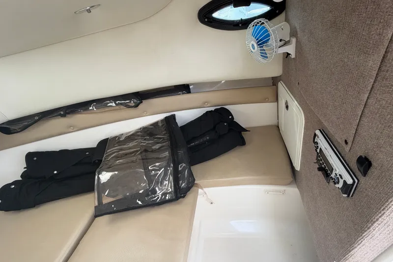 Slide: The Image of Interior cabin of a 2006 Century 2200 Walk-Around boat with seating and fan. - 10