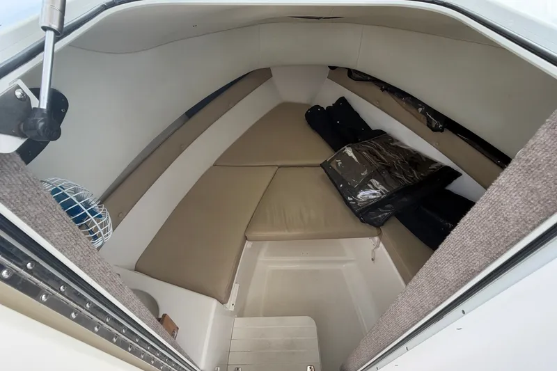 Slide: The Image of Interior cabin of a 2006 Century 2200 Walk-Around boat with beige cushions. - 8