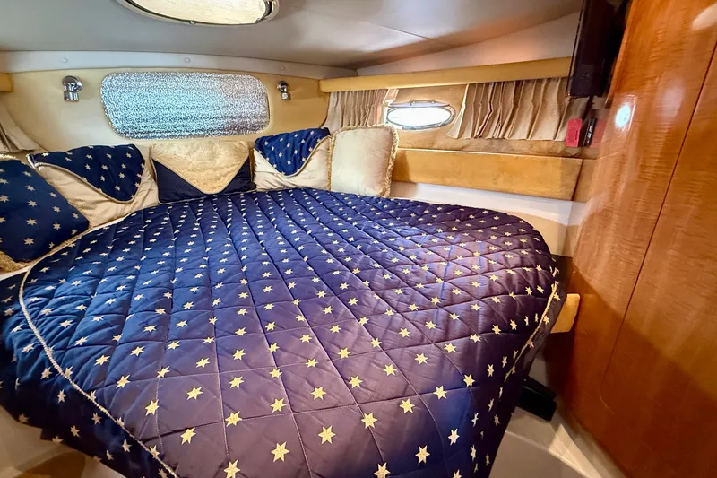 Slide: The Image of Luxurious cabin interior of 2003 Regal Commodore 3880 with star-patterned bedding. - 44