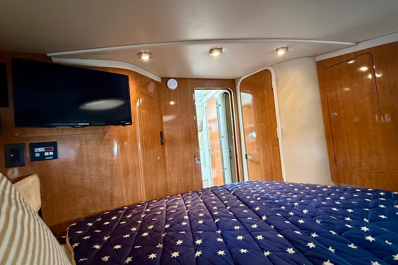 Slide: The Image of Luxurious cabin interior of 2003 Regal Commodore 3880 yacht with star-patterned bedding. - 45