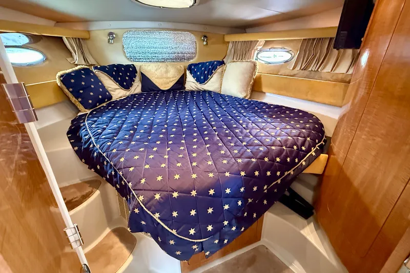 Slide: The Image of Luxurious cabin interior of 2003 Regal Commodore 3880 with star-patterned bedding. - 42