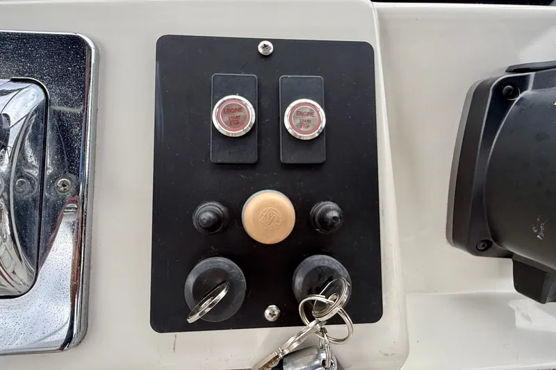 Slide: The Image of Control panel of a 2003 Regal Commodore 3880 boat with engine start buttons. - 28