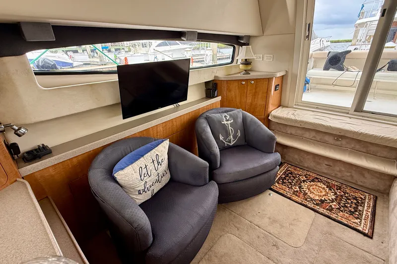 Slide: The Image of Interior of 2003 Regal Commodore 3880 yacht with cozy seating and nautical decor. - 34