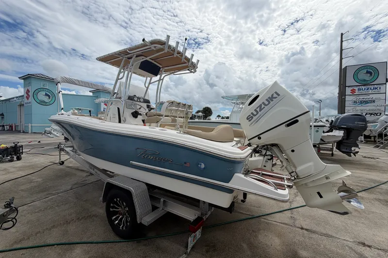 Slide: The Image of 2020 Pioneer 202 Islander boat with Suzuki outboard motor on trailer, outdoor dealership setting. - 5