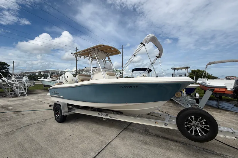 Slide: The Image of 2020 Pioneer 202 Islander boat on trailer under cloudy sky. - 1