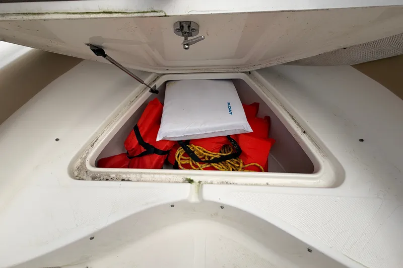 Slide: The Image of Storage compartment of 2020 Pioneer 202 Islander boat with life jackets and rope. - 10