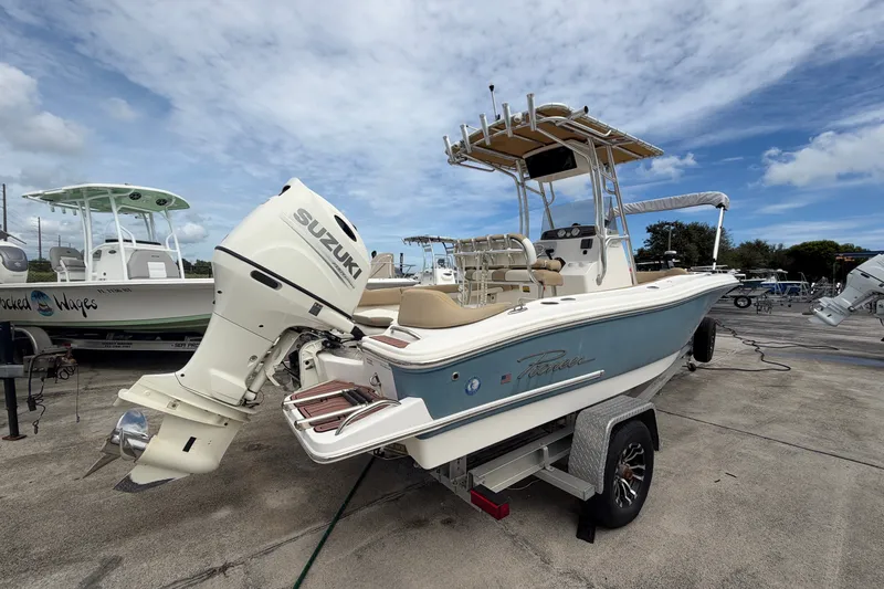 Slide: The Image of 2020 Pioneer 202 Islander boat with Suzuki outboard motor on trailer, under a cloudy sky. - 3